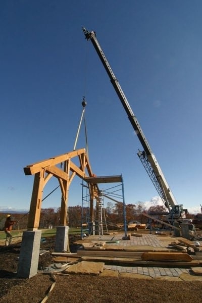 using a crane to raise a frame on raising day