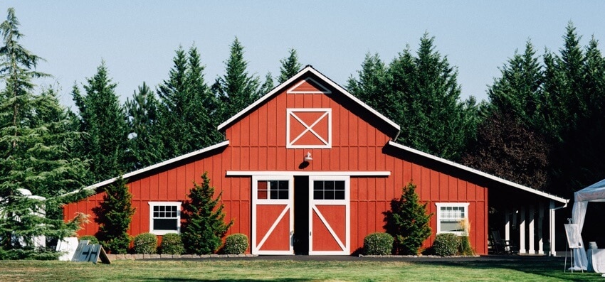 red timber frame barndominium