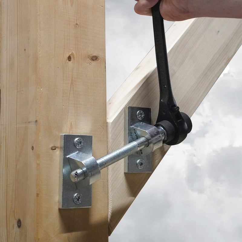 Geko Mini panel puller being operated with Cricket ratchet wrench on a timber frame post and beam joint