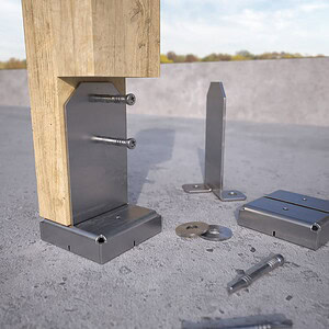 Easy Tie post base kit assembly showing knife plate, standoff riser, base plate, washers, and self-drilling dowels on concrete
